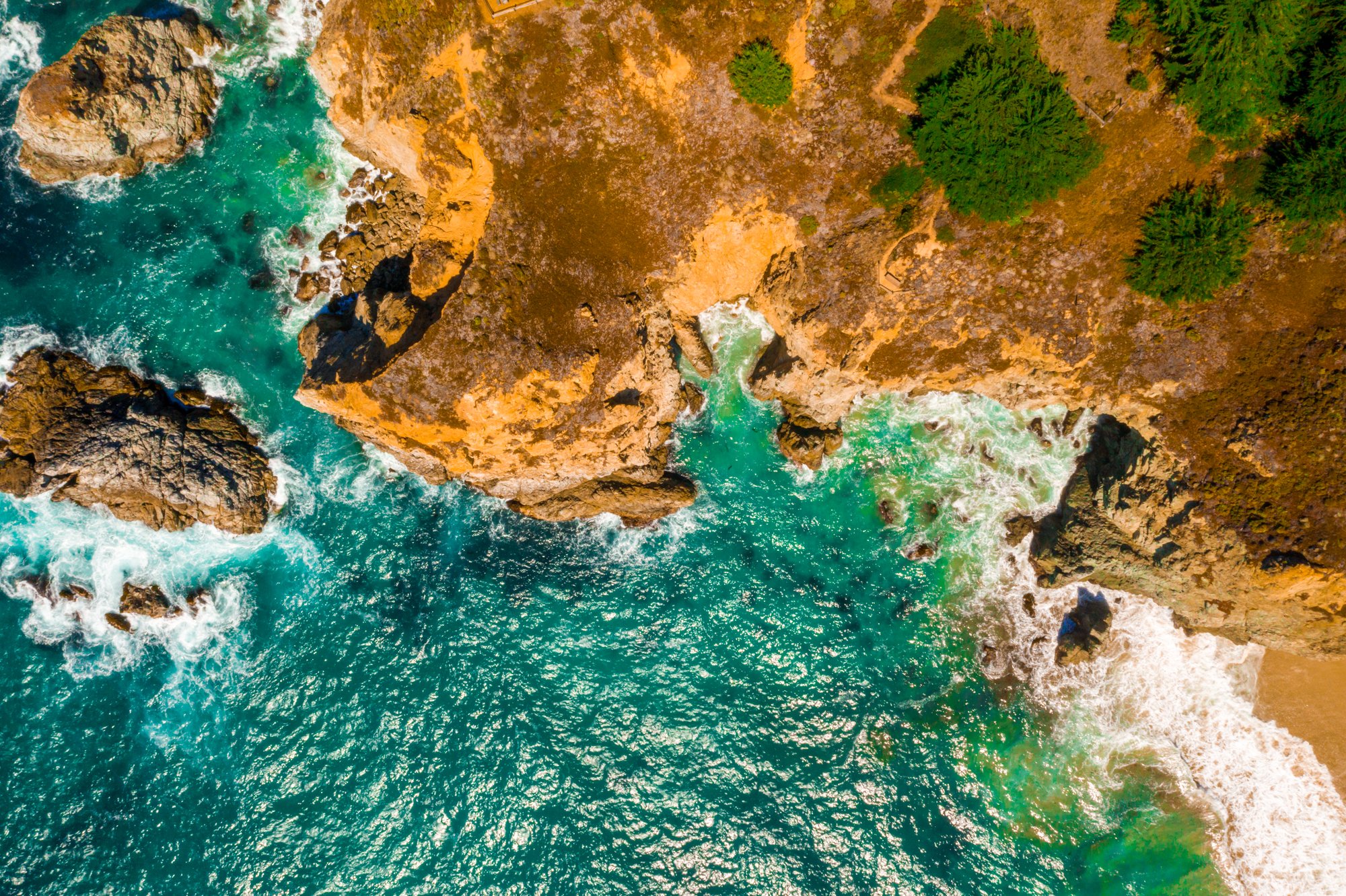 aerial-shot-wavy-sea-against-cliffs-daytime