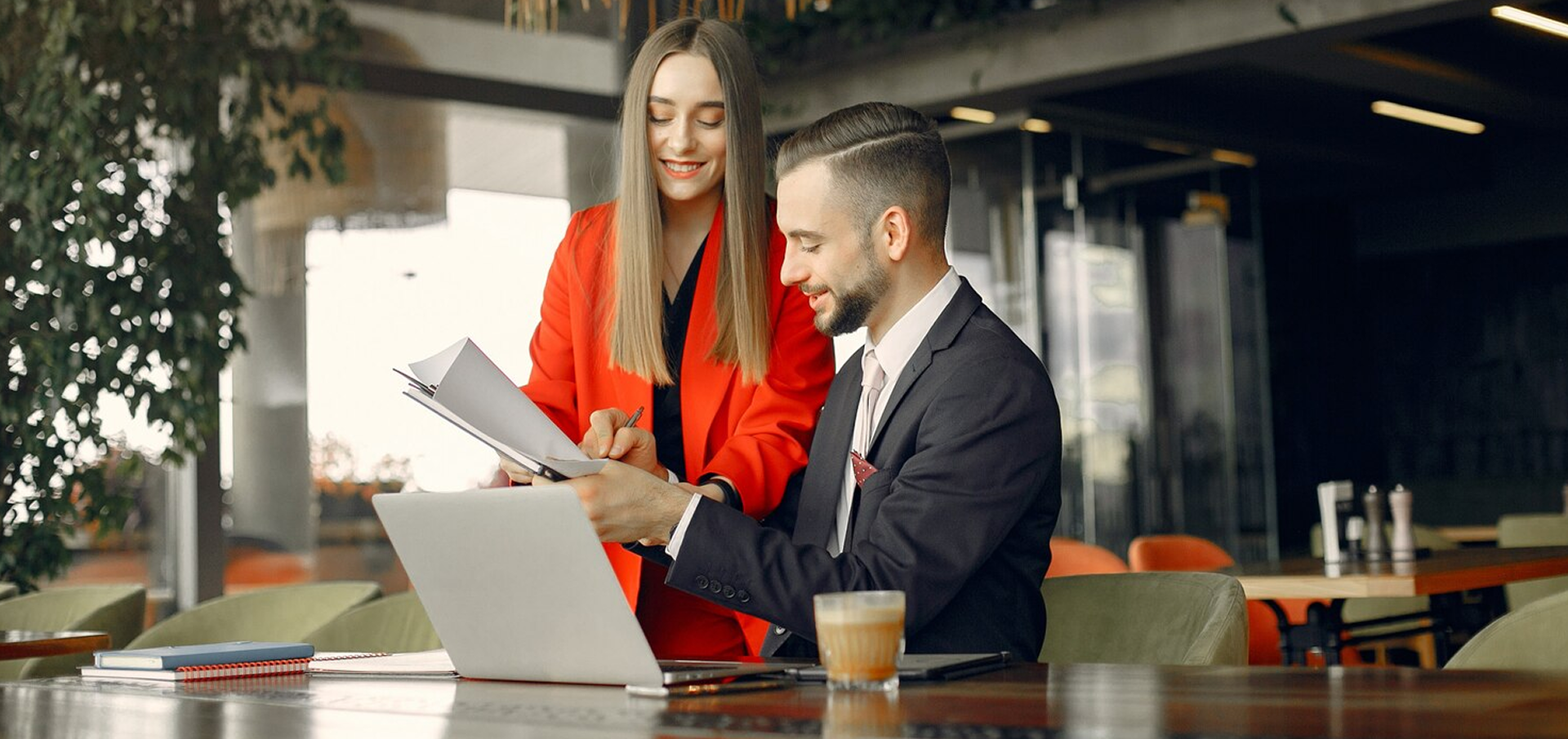 partners-sitting-table-working-cafe_1157-28469 1